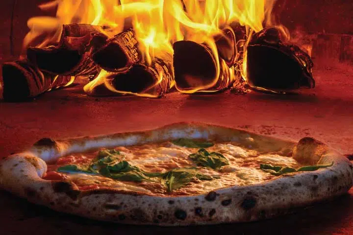 A pizza sitting on top of a wooden board.