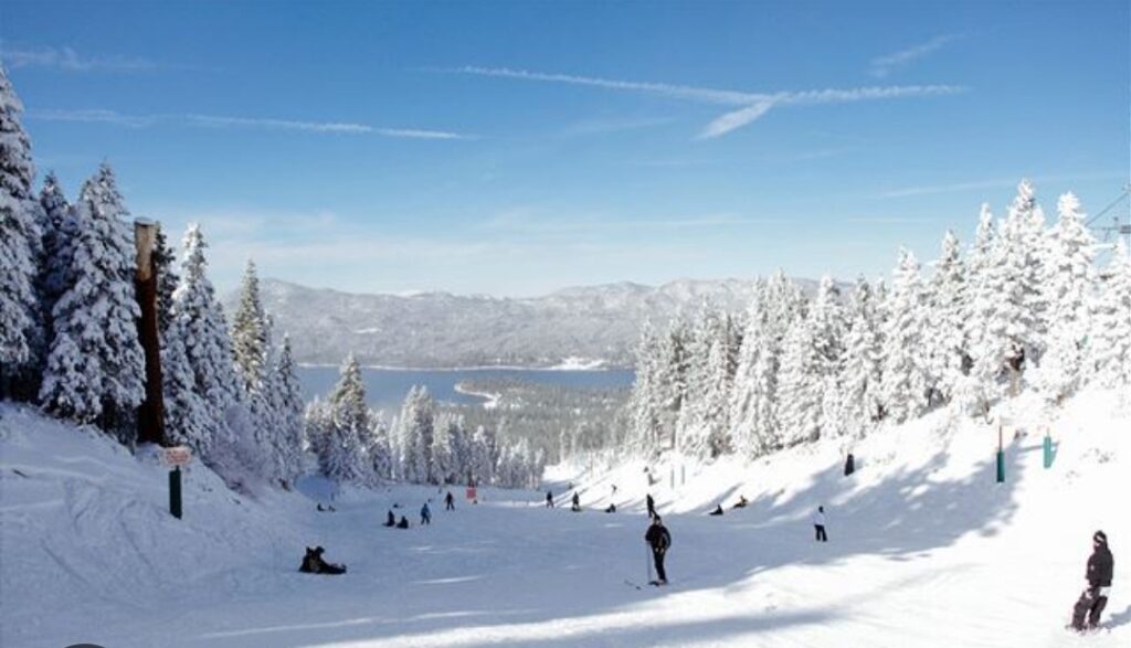 A group of people skiing down the side of a mountain.