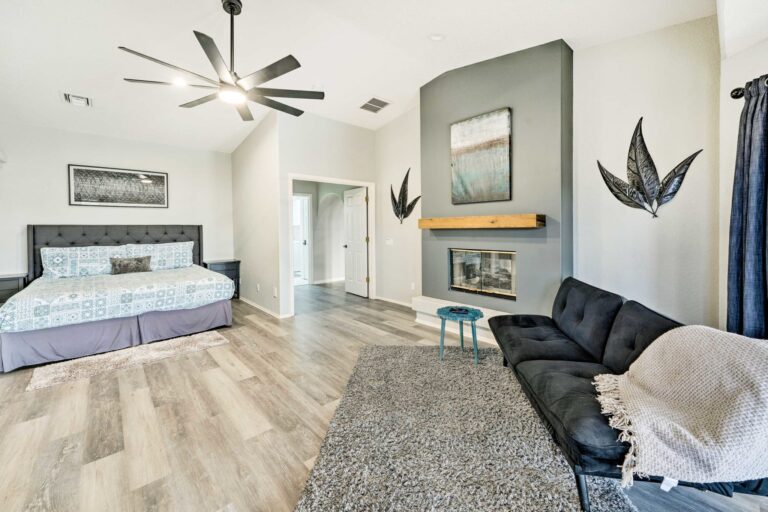 A living room with a fireplace and a bed