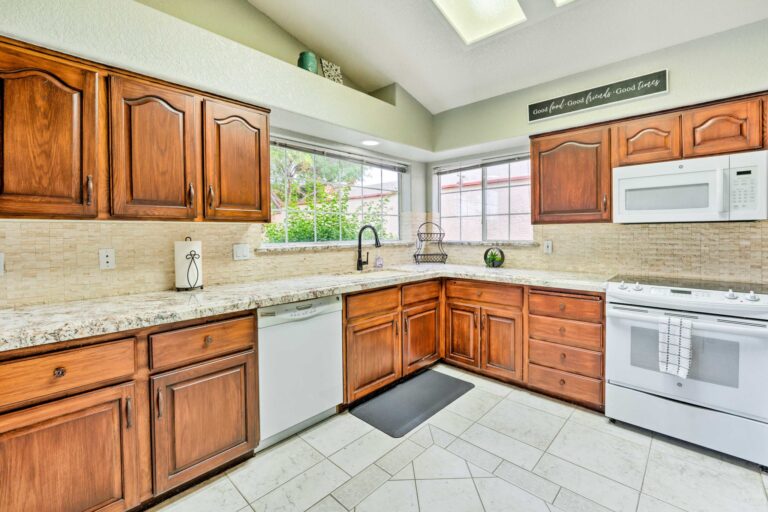 A kitchen with wooden cabinets and white appliances.