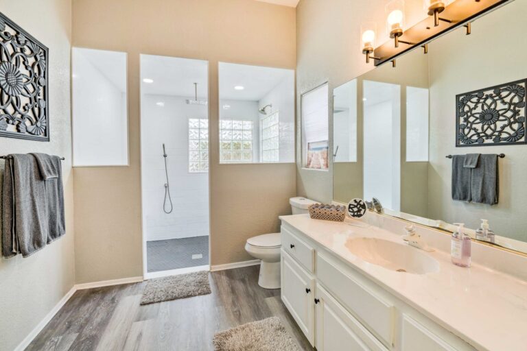 A bathroom with white cabinets and a toilet.